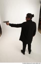 Man Adult Average Black Fighting with gun Standing poses Coat